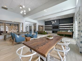 A dining room and living room with a wooden table and chairs